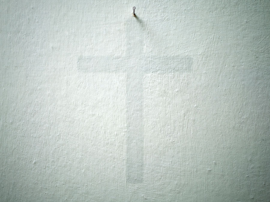 Crucifix. Old wall with the sign of a crucifix.